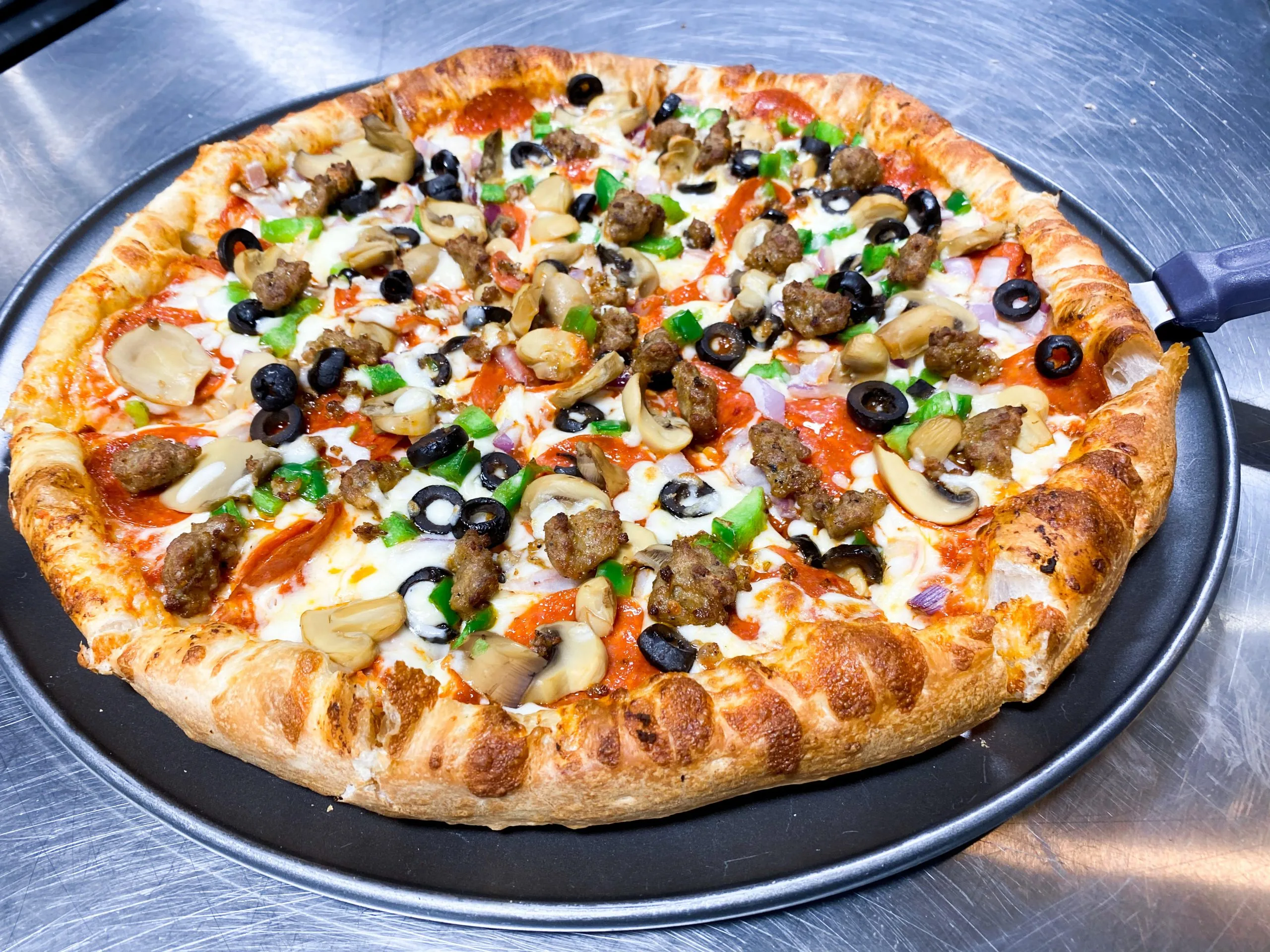 Delicious Deluxe pizza in Calgary, AB